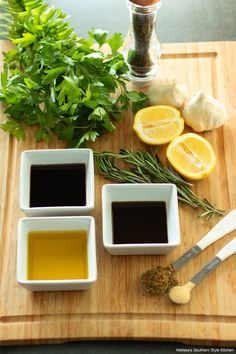 the ingredients to make this dish include lemons, herbs and olive oil on a cutting board