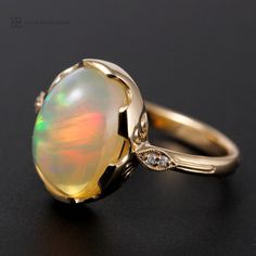 Welo Opal Ring, 10 x 13 mm  3.67 carat, 4 diamonds SI g-h round brilliant natural diamonds. 14k yellow gold ring, bezel set, leaf accents with diamonds Size 7, scallop bezel, top width 14.5mm shank has a slight taper, the bottom width is 2.5mm and 1.30 mm thick, the shank is a half round soft finish full polish. There are two diamond in each leaf. This opal is full off color, it is very hard to photograph opal, this one has red green and yellow broad flash. the color shows from every angle. This is a very nice opal. This is also called  Ethiopian opal. Kingdom Hearts Ring, Opal Band, Ring Bezel, Etsy Gold Ring, Opal Ring, Welo Opal, Yellow Gold Ring, Drop Pendant, Green Crystals