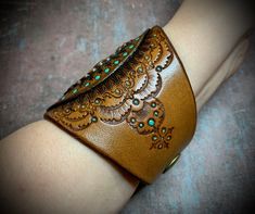 Bohemian Cuff Leather Bracelet Gift, Traditional Leather Jewelry For Festival, Traditional Handmade Leather Bracelets, Traditional Adjustable Leather Jewelry, Traditional Handmade Brown Cuff Bracelet, Bohemian Stamped Leather Bracelet, Traditional Handmade Leather Jewelry, Hand Tooled Brown Cuff Jewelry, Adjustable Hand Tooled Turquoise Cuff Bracelet