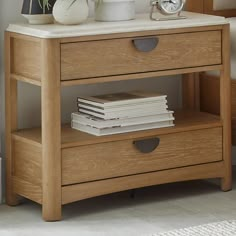 a wooden table with two drawers and a clock on top