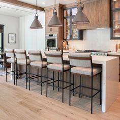 a kitchen filled with lots of counter top space next to a dining room table and chairs