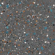 an asphalt surface with multicolored dots and small black spots on it, as well as the ground