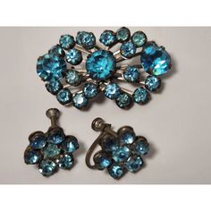 This set is very old and about 100 years old. Two earrings with screw backs and one pin/brooch.  The brooch has 23 blue stones/glass (20 smaller and 3 large) and each earrings has an additional 7 clusters each. Total stones 37 in the set. Antique Blue Jewelry With Brooch, Vintage Sapphire Brooch Jewelry, Vintage Blue Brooches For Jewelry Making, Vintage Sapphire Jewelry For Collectors, Vintage Blue Jewelry Brooch, Vintage Sapphire Brooches For Gifts, Vintage Sapphire Brooches As Gift, Vintage Blue Clip-on Jewelry, Vintage Brooches With Matching Earrings For Gift