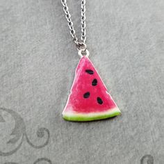 "This listing is for a watermelon slice charm necklace. You'll be able to choose your chain length and style at checkout by using the \"Chain Length/Style\" drop-down menu. Keyrings, bangle bracelets, ball chains, and black/brown leather and suede cord are also available. **Please see the second photo for scale! If you're on the mobile site, just swipe to the side. :) - - - - - - - Sign up for our newsletter to receive coupons and updates on new items! Follow the link: ♦ ♦ ♦ http://eepurl.com/cG Trendy Nickel-free Sterling Silver Charm Necklaces, Cute Nickel-free Metal Charm Necklace, Cute Nickel-free Metal Charm Necklaces, Cute Metal Charm Necklace Nickel Free, Watermelon Colored Summer Jewelry Gift, Summer Watermelon Colored Jewelry For Gift, Cute Nickel-free Round Necklaces, Green Nickel-free Pendant Charm Necklace, Everyday Summer Metal Jewelry