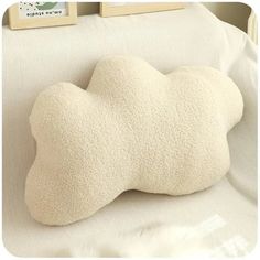 the pillow is shaped like a dog's head and has been placed on top of a bed