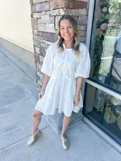 Add a touch of elegance to your wardrobe with the Chic Moment Eyelit Bow Tier Dress in white. This dress features delicate eyelit detailing and a charming bow, making it the perfect choice for any occasion. You'll feel confident and lovely in this stylish and sophisticated piece! Ashlyn is wearing a size small, which is her typical size for dresses! Casual Eyelet Dress For Brunch, White Casual Eyelet Dress, White Eyelet Dress For Brunch, White Broderie Anglaise Mini Dress For Brunch, White Eyelet Dress For Spring, Eyelet Dress For Day Out In Spring, Spring Eyelet Dress For Day Out, Elegant Spring Mini Dress With Eyelet Details, Spring Elegant Eyelet Mini Dress