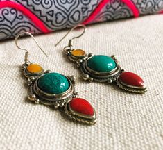 Gift idea ! Ethnic and elegance! A very beautiful pair of earrings made of Tibetan silver, Coral turquoise and Amber colored resin. They will accompany your outfits in a vintage boho ethnic style. They are mounted on 925 silver. Length under attachment: 4.5 cm They are shipped with a small traditional fabric pouch and tips. Shipping will be fast and careful. Jewelry Crafts Tibet Nepal: the NEPALMASHOP.FR store Tibetan Earrings, Fabric Pouch, Natural Stone Jewelry, Ethnic Earrings, Traditional Fabric, Amber Color, Coral Turquoise, Ethnic Style, Ethnic Fashion