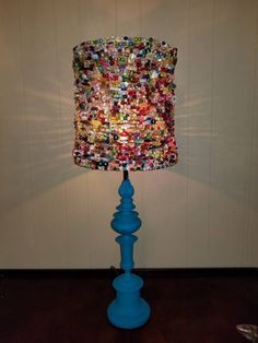 a blue table lamp with buttons on it and a light shade hanging from the top