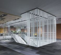 an office building with glass walls and stairs