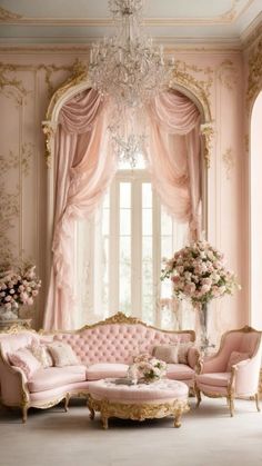 an elegant living room with pink furniture and flowers on the table in front of it