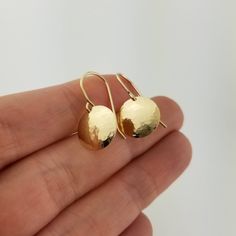 "Made from solid 14 karat gold, these lightweight earrings are hammered and then slightly domed for an elegant appearance perfect for daily wear. Metal: Solid 14k Yellow Gold Disc Diameter: Choose from 3/8\", 1/2\" (pictured), or 5/8\" Matching Necklace can be found here: https://www.etsy.com/listing/772633456/ Packaged for gifting! Each piece of jewelry in my shop is individually handcrafted by me in my studio. If you have any questions, please send me a convo by hitting the 'Ask a question' li Anniversary Hammered Yellow Gold Earrings, Elegant Hammered Everyday Earrings, Hammered 14k Gold Earrings For Gift, Hammered Teardrop Earrings For Anniversary, Hand Forged 14k Gold Round Earrings, 14k Gold Hand Forged Drop Earrings, Oval Hammered Earrings For Anniversary, Hammered Teardrop Earrings For Formal Occasions, Hammered Yellow Gold Earrings Made Of Recycled Gold