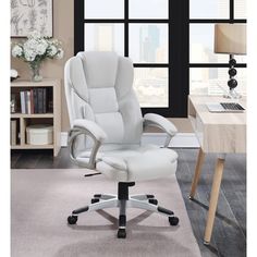 a white office chair sitting on top of a rug in front of a large window