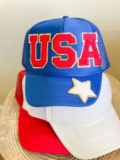 "The perfect accessory for the summer and all the patriotic events!! Hat comes with USA red patches and one white star patch on the bill. Choose your color hat to fit your style. We have several color options to choose from. Hat Details: 100% Polyester foam front, mesh back Structured, five-panel, mid-profile 3 ½\" crown Pre-curved visor with braid detailing Adjustable double snapback closure" Summer Patriotic Trucker Hat With Curved Brim, Patriotic Snapback Baseball Cap For Summer, Patriotic Snapback Summer Hats, Patriotic Snapback Hat For Summer, Patriotic White Hat For Summer, Patriotic Summer Snapback Trucker Hat, Blue Baseball Cap For 4th Of July, White Baseball Cap For 4th Of July, Red Baseball Cap For 4th Of July