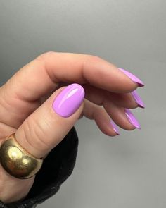 a woman's hand with pink and gold nail polish