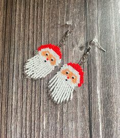 Get into the festive spirit with these adorable hand beaded Santa earrings! These earrings are meticulously crafted with love and attention to detail, featuring a jolly Santa Claus design that will bring joy to your holiday season. Whether you're attending a Christmas party, spreading holiday cheer, or simply want to add a touch of whimsy to your everyday look, these earrings are the perfect accessory. They also make a great gift for friends and loved ones who love the magic of Christmas. Order Christmas Beading, Santa Earrings, Beaded Earring, Jolly Santa, The Magic Of Christmas, Magic Of Christmas, Christmas Gift For Her, Earrings Beaded, Jewelry Christmas