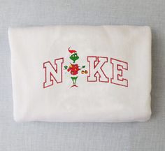 embroidered pillow case with the word'n ike in red and green flowers on it