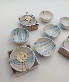 blue and white dishes with tags tied to them