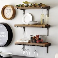 two shelves with wine glasses and plates on them