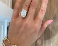 a woman's hand with a diamond ring on it