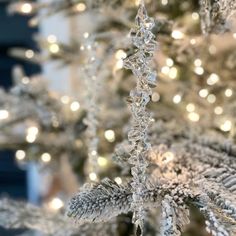 a white christmas tree with snow flakes on it