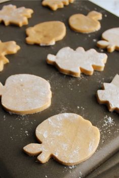 some cookies are sitting on a cookie sheet and ready to be cut into smaller shapes