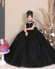 Elevate your little one's presence with our stunning black princess ball gown, perfect for birthdays, pageants, or as a luxurious flower girl dress. Designed for comfort and style, order now to enchant your girl with glamour! ----DETAILS---- > Floor Length > Round Neck with Band Collar > Sleeveless ----ITEM MATERIAL---- Upper layer of the skirt- Glitter Tulle Middle layer of the skirt- Tulle Lower layer of the skirt- Satin Bodice of the dress- Glitter Moonlight, Satin -----COLOR----- If you want Black Gown For Quinceanera, Princess Evening Ball Gown Pageant Dress, Princess Style Ball Gown Pageant Dress For Evening, Princess Style Evening Ball Gown Pageant Dress, Elegant Black Ball Gown For Quinceanera, Black Tulle Ball Gown For Party, Elegant Quinceanera Gown, Princess Style Ball Gown Tutu Dress For Quinceanera, Princess Style Tutu Dress For Quinceanera