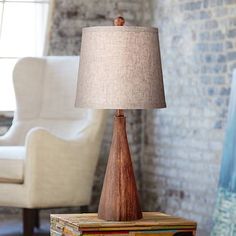 a table lamp sitting on top of a stack of books