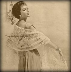 an old photo of a woman wearing a shawl and holding her hand on her hip