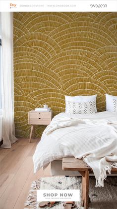 a bedroom with yellow wallpaper and white bedding