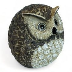 an owl figurine is shown on a white background