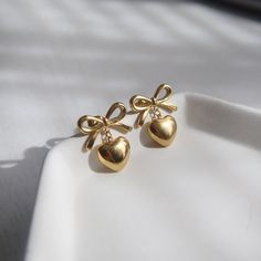 Add a touch of femininity to your outfit with our lovely Bow Heart Earrings. The bow design is adorned with a charming heart, making them the perfect accessory for any occasion. -stainless steel, gold plated How To Take Earring Photos, Cute Bow Earrings, Cute Earrings Aesthetic, Korean Jewellery, Jewelry Bow, Xoxo Jewelry, Trending Earrings, Aesthetic Earrings, Feminine Necklace