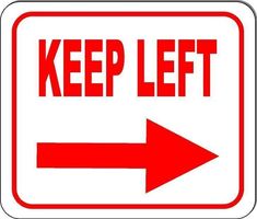 a red and white keep left sign with an arrow