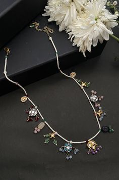 This necklace is a dainty, delightful piece. With a collection of quirky little unit, embellished with colorful stones and pearls, this necklace is perfect piece for the lovers of eccentric designs. Closure - Lobster Style Tip - Meet the perfect amalgam of poetic romance and the surrealism of fairy tales. Reminding us of clear starlit skies, magic and all the poems about love and passion, these designs are perfect for someone who wishes to add poetic details to their selections which are also re Temple Jewelry Style Jeweled Necklace As Gift, Jeweled Temple Jewelry Necklace As Gift, Temple Jewelry Style Necklace As A Gift, Multicolor Party Necklaces With 17 Jewels, White Jeweled Necklaces For Festivals, White Jeweled Necklace For Festivals, White Jeweled Kundan Necklace Gift, Traditional Multicolor Jewels Necklace, Multicolor Jeweled Pendant Necklace