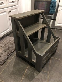 a chair sitting on top of a kitchen floor next to a shelf