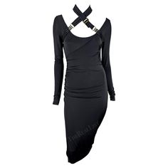 Presenting a fabulous black Gucci bodycon dress, designed by Tom Ford. From the Fall/Winter 2003 collection, this dress features long sleeves, a knee-length hem, and a low scoop neckline. Made complete with belt buckles that can be wrapped around the waist or fashioned as a halterneck, this sexy Guci by Tom Ford dress is the perfect addition to any wardrobe! Approximate measurements: Size - S Shoulder to cuff: 29" Armpit to cuff: 25" Bust: 26 - 36" Waist: 24 - 32" Hips: 32 - 44" Tom Ford Dress, Gucci By Tom Ford, Ford Black, Tom Ford, The Fall, Day Dresses, Dresses For Sale, Convertible, Knee Length