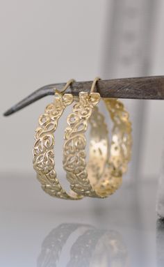 Large 14k solid gold hoop earrings. #gooldhoop #14kgoldearrings #14kgoldhoopearrings #hoopearrings #largehoop Gold Plated Filigree Hoop Earrings, Gold-plated Filigree Hoop Earrings, Brass Filigree Hoop Earrings For Wedding, Small Hoop Gold Filigree Earrings, Brass Hoop Earrings With Intricate Design, Brass Filigree Hoop Earrings, Gold Filigree Hoop Jewelry, Gold Pierced Hoop Jewelry, Small Hoop Filigree Earrings As Gift