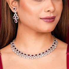 Ruby Necklace Set  features a stunning red stone paired with sparkling cubic zirconia and red diamonds. The classic and elegant design makes it a perfect statement piece for a bride or special occasion. This ruby necklace set is an ideal wedding gift, adding timeless beauty and luxury to her jewelry collection. *𝐏𝐑𝐎𝐃𝐔𝐂𝐓 𝐃𝐄𝐓𝐀𝐈𝐋* * 𝐌𝐚𝐭𝐞𝐫𝐢𝐚𝐥: Brass * 𝐏𝐥𝐚𝐭𝐢𝐧𝐠: White Rhodium Plated * 𝐒𝐭𝐨𝐧𝐞: AAA-quality CZ Diamond. *𝐃𝐈𝐌𝐄𝐍𝐒𝐈𝐎𝐍𝐒* *𝐍𝐞𝐜𝐤𝐥𝐚𝐜𝐞* * 𝐖𝐞𝐢𝐠𝐡 Red Diamond Necklace With Brilliant Cut, Red Cubic Zirconia Jewelry Sets For Celebration, Red Cubic Zirconia Jewelry Sets, Fine Jewelry Red Diamond Necklace With Brilliant Cut, Red Diamond Necklace With Accents, Formal Bridal Necklace With Rhinestones And Diamond, Red Diamond Round Necklace For Anniversary, Formal Jewelry Sets With Diamonds And Rhinestones, Formal Diamond Necklace With Rhinestones