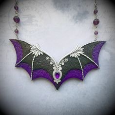 This statement purple and black Gothic bat wings necklace is hand-sculpted of polymer clay and decorated with amethyst gem. Would be perfect for a Halloween witch outfit. Necklace length - 20 inches Bib height - 2 inches Bib width - 4.25 inches Can be made in different colors and sizes - please feel free to contact me if you need a special piece. Black Fantasy Jewelry For Costume, Black Fantasy Costume Jewelry, Fantasy Black Costume Jewelry, Handmade Purple Fantasy Necklaces, Handmade Purple Fantasy Necklace, Fantasy Style Amethyst Purple Jewelry, Fantasy Style Purple Amethyst Jewelry, Purple Amethyst Fantasy Jewelry, Gothic Black Amethyst Jewelry