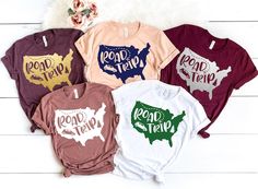 four t - shirts with the words road trip and usa in different colors on them