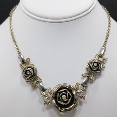 *Description: This is a vintage 3D rose necklace & screw back earring set with clear rhinestone centers from the late 1940s to 1950s. The necklace has three roses with the largest in the center. The matching screw back earrings have the same 3D design with a single rose center and two leaves on each with the clear rhinestone center. I tested the surface since they look silver tone with a gold wash. The gold wash tested at 10K gold and the metal under the gold wash is magnetic and silver in t Silver Rose Design Jewelry For Formal Occasions, Vintage Rose Gold Jewelry For Evening, Rose Gold Vintage Jewelry For Evening, Vintage Rose Design Jewelry For Formal Occasions, Victorian Rose Design Jewelry For Formal Occasions, Vintage Metal Jewelry With Rose Design, Vintage Silver Necklace With Rose Design, Vintage Silver Necklaces With Rose Design, Three Roses