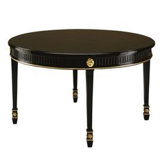 a black table with gold trimmings on the top and legs, against a white background