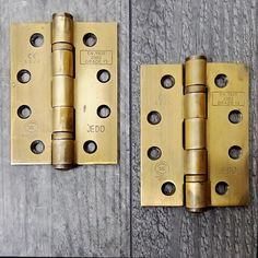 two brass door hinges with holes in them