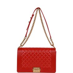 This New Medium Boy bag is in red quilted lambskin with antique gold tone hardware and features a full front flap with the Le Boy CC push lock closure and an antique gold tone chain link and red leather padded shoulder/crossbody strap. The interior is lined in red fabric with an open pocket on rear wall. Collection: 21-series Origin: France Condition: ; Mint- the bag shows some light wear to the leather and some very light wear to the interior pocket. Accompanied by: Chanel box, Chanel dustbag, Chanel Box, Red Quilts, Vuitton Bag, Red Fabric, New Media, Crossbody Strap, Luxury Items, Antique Gold, Gold Hardware