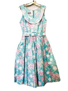 Robbie Bee Vintage 1980’s Beautiful Sky Blue with Pink Roses & Lillies Sleeveless Scoop Neck Belted Zip Back Cottagecore Dress Size 10. This dress has two side/pockets and is 100% cotton chintz. Measures 16” armpit to armpit, 16 1/2” shoulder to waist, 29” waist to hem, 46” Long. Excellent preowned condition, pictures do not do this dress justice, no rips, stains or tears. From a smoke free home. Shipped with USPS Priority Mail. Same or next day shipping. Fitted Vintage A-line Sleeveless Dress, Summer Sleeveless Vintage 1950s Style Dress, 1950s Style Sleeveless Summer Vintage Dress, Vintage A-line Sleeveless Dress For Party, Sleeveless Vintage Dress For Summer Party, Vintage Sleeveless Party Dress, Vintage Fitted A-line Sleeveless Dress, Sleeveless Blue Dress For Vintage Fashion, Spring Vintage Sleeveless Dress For Parties