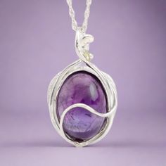 This "Murazaki" pendant necklace is handmade of 999 fine silver. It has been hand crafted in pure 99.9% solid silver in my workshop. It features a translucent Amethyst gemstone. "Murazaki" means "purple" in japanese. NOTE: This piece of jewelry has been created around this one-of-kind gemstone. It is unique and cannot be reproduced. Only one available! Silver Wire Wrapped Necklaces, Fusion Style Sterling Silver Hallmarked Necklace, Purple Artisan Sterling Silver Jewelry, Artisan Sterling Silver Purple Jewelry, Artisan Purple Sterling Silver Jewelry, Artisan Sterling Silver Jewelry In Purple, Unique Hand Forged Purple Necklaces, Sterling Silver White Gold Necklaces With Natural Stones, Nature-inspired Sterling Silver Wire Wrapped Necklaces