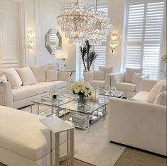 a living room filled with furniture and a chandelier