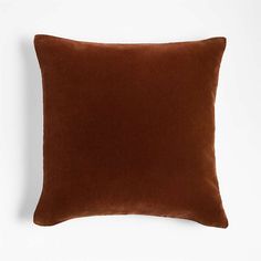 a brown pillow on a white wall