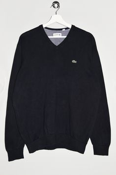 "Lacoste v-neck sweater in black. - Size tag: Please always check measurements before buying. Tag reads Men's XL, but fits like Men's L. - Measurements (laying flat): Pit to Pit: 21.5\" Length: 27\" Sleeve: 25\" Pit to Cuff: 19\" Across the shoulders: 17.5\" -Wear: /Please see images for details/ Good used condition. Slight color fading at places. - Fabric: Cotton *All of our items are preloved pieces so some signs of natural wear and age are to be expected. Please look through the photos carefully to check if the condition is to your satisfaction. *All efforts are made to show any defects however small imperfections may be missed. *We try to describe the sizes as accurately as possible, but please keep in mind that sizes nowadays can differ to sizes used back then. Please note the measure Black Cotton V-neck Winter Sweater, Black Cotton V-neck Sweater For Winter, Casual Black V-neck Sweater, Black V-neck Cotton Sweater, Black Cotton V-neck Sweater, Cotton V-neck Sweater With Ribbed Cuffs, Black Casual V-neck Sweater With Ribbed Cuffs, Sporty Cotton V-neck Sweater, V Neck Sweater Men