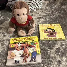 there are two children's books and a stuffed monkey on the floor next to each other