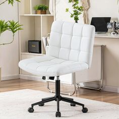 a white office chair sitting on top of a wooden floor in front of a desk